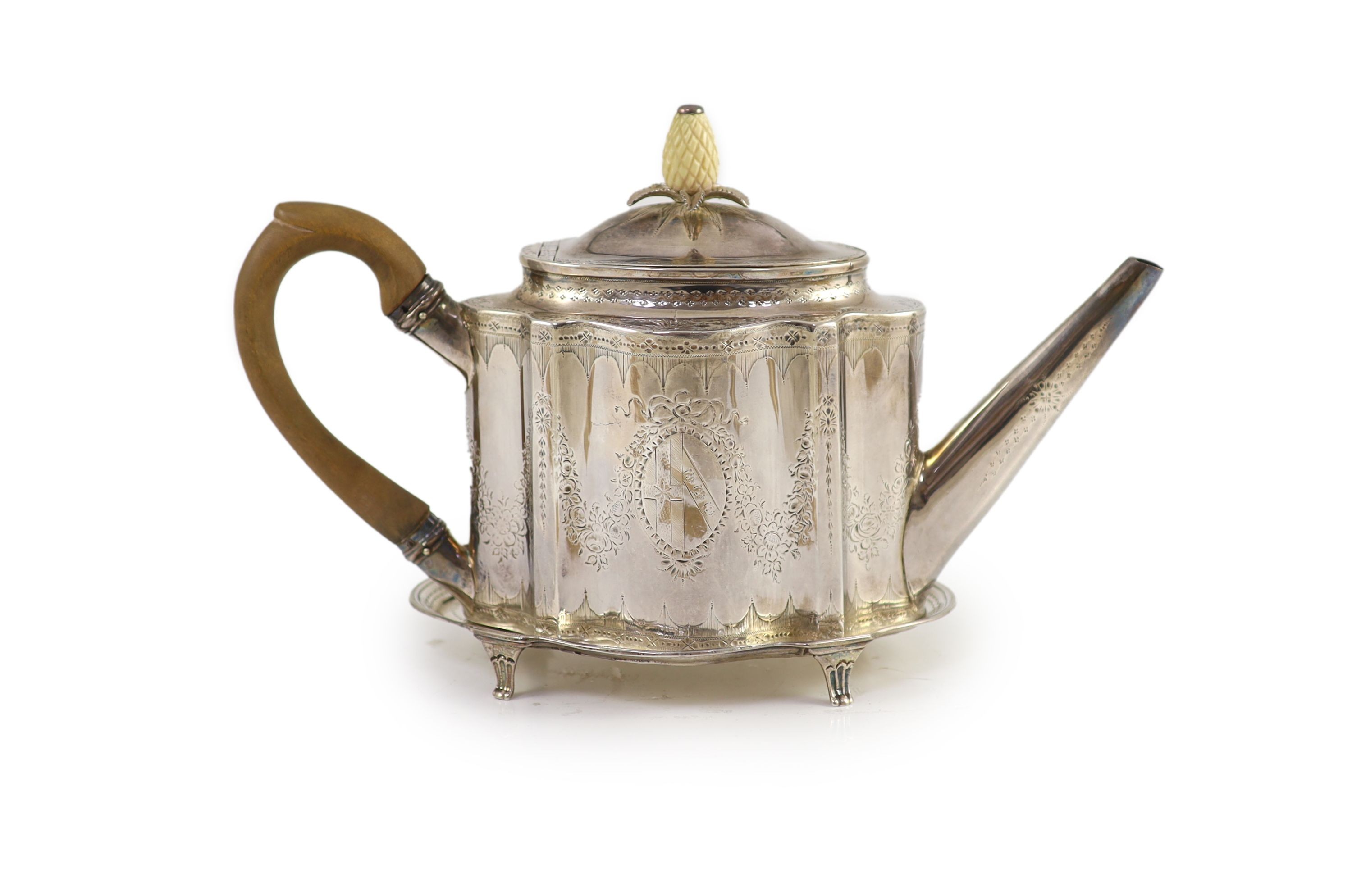 A George III silver bright cut engraved oval teapot and stand, Thomas Daniell